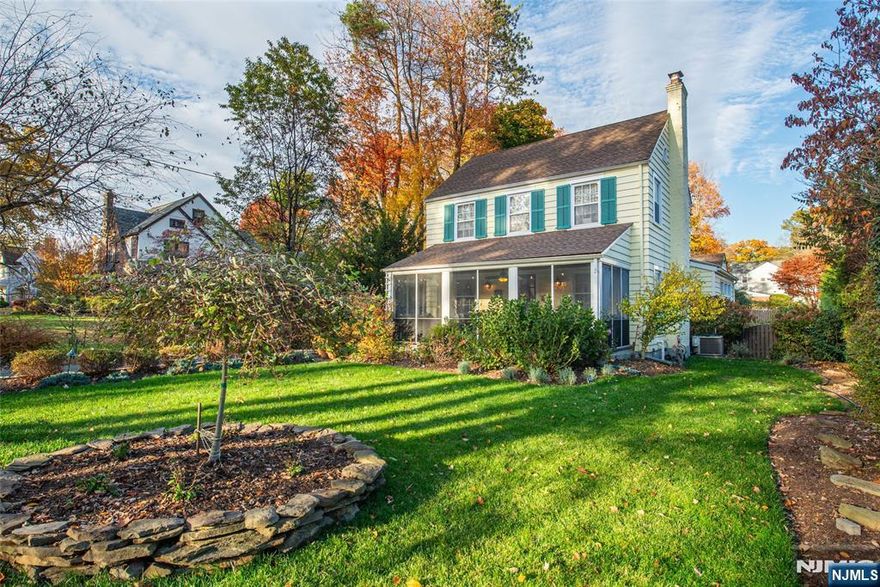 There's just something Magical & Enchanting about The Cedars and this 1932 storybook Colonial captures it all! Bursting with character and warmth, this home blends classic architecture with Georgian charm! Forget "curb appeal this screened porch with brick flooring has main-character energy from the moment you arrive leading into a light-filled living room with custom built-ins, rich hardwood floors and a crackling wood-burning fireplace. The kitchen has undeniable flair bright, bold & full of charm, anchored by a statement Bertazzoni red range, crisp white cabinets, farmhouse sink, clean subway title backsplash and a pantry for storage. Formal dining room located just off kitchen perfect for entertaining and serving. Rear family room with skylights and easy access to rear yard! A fresh and airy full bath pairs character with modern polish patterned floors and thoughtful finishes that feel effortlessly timeless. Upstairs, 3 bedrooms and bathroom that pays tribute to 1932 captures the home's timeless appeal classic moldings, gleaming hardwoods, and designer fixtures that make every space feel elegant. Step outside and it's pure backyard magic featuring paver patio, composite style deck and a fenced yard are just some of the reasons you'll volunteer to host the next barbecue. Located just outside of Downtown Caldwell shops, restaurants, schools, Grover Cleveland Park & NYC transportation! Just one visit to this home and you'll understand why the location is so special!