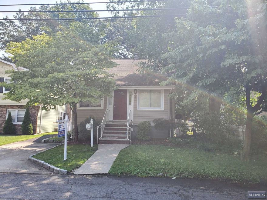 Great opportunity to own in Dumont and the great school system! This home features four bedrooms and two full baths. The first floor has Updated kitchen, living room, dining room one bedroom, washer, dryer and full bath. Seconnd floor has two bedrooms.The basement has bonus living space with seperate entrance, large family room, one bedroom,New Updated full bath, laundry room. Enjoy BBQing on large shaded deck. The house has dual street access with multiple driveways and detached garage. Sold AS-IS