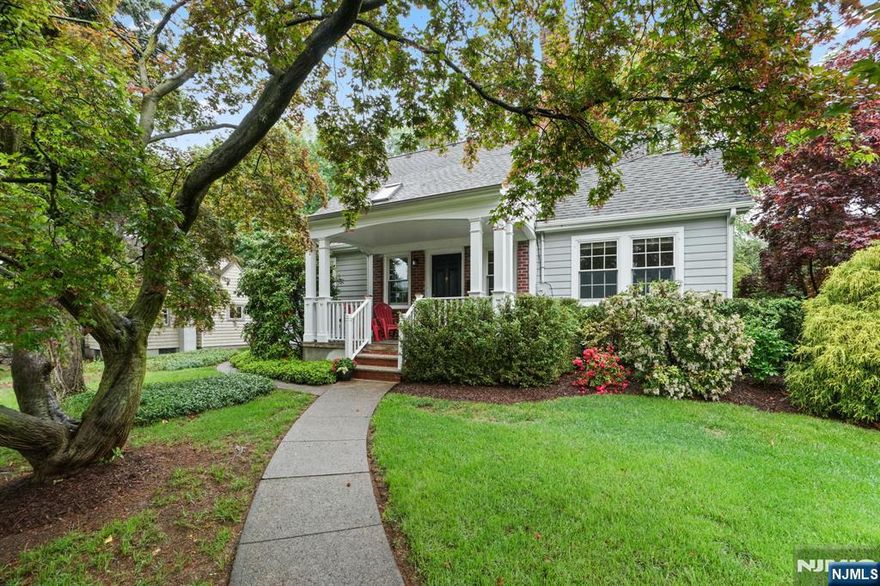 This storybook Colonial may be one of the prettiest homes in Midland Park! With its outstanding curb appeal and picturesque corner lot, this classic home blends timeless charm with thoughtful updatesâ€”starting with a pretty front porch thatâ€™s perfect for morning coffee or chatting with neighbors. Inside, rich chestnut trim and elegant archways echo the craftsmanship of a bygone era. The first floor offers a rare find: a spacious primary suite, along with a sun-filled living room, a formal dining room framed by a stunning arched doorway, a sunroom, powder room, and a large kitchen with abundant counter space and an 8â€™ foot islandâ€”ideal for gathering, cooking, or casual meals. Upstairs, youâ€™ll discover three additional bedrooms and a full bath. The finished basement adds great bonus space with a rec room and a built-in barâ€”perfect for entertaining or relaxing weekends. Step outside to enjoy a fenced backyard, paver patio, and an oversized 1.5-car garage. All of this is tucked into one of Midland Parkâ€™s most desirable neighborhoods, close to schools, parks, and downtown conveniences.