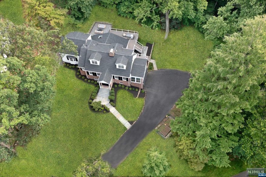 Fabulous and spacious Custom Home located at the end of a quiet cul de sac on over an acre of stunning property with loads of recent upgrades and renovations! Perched gracefully on magnificent property, this sprawling home is 2 blocks to Hartshorn Elementary featuring convenient 1st floor Primary Suite, renovated Lower Level with Full Bath, updated Sunroom + new Trex Deck with built-in fire-pit. Open floor plan with great flow - front-to-back formal Living Room with statement fireplace and direct access to Sun Room / Office. Family Room opens to Gourmet Kitchen with Breakfast area. Dining Room leads to Dining Room. Primary Wing features walk-in closet, dressing area and Full Bath. Updated Powder Room and Laundry Room complete main level. 2nd level boasts 3 generous bedrooms + 2 full baths. Magnificent NEW Lower Level with Full Bath, Rec Room and Media Room with bar. Out of this world property and backyard features a spectacular new Trex Deck with LED light posts and fire-pit.