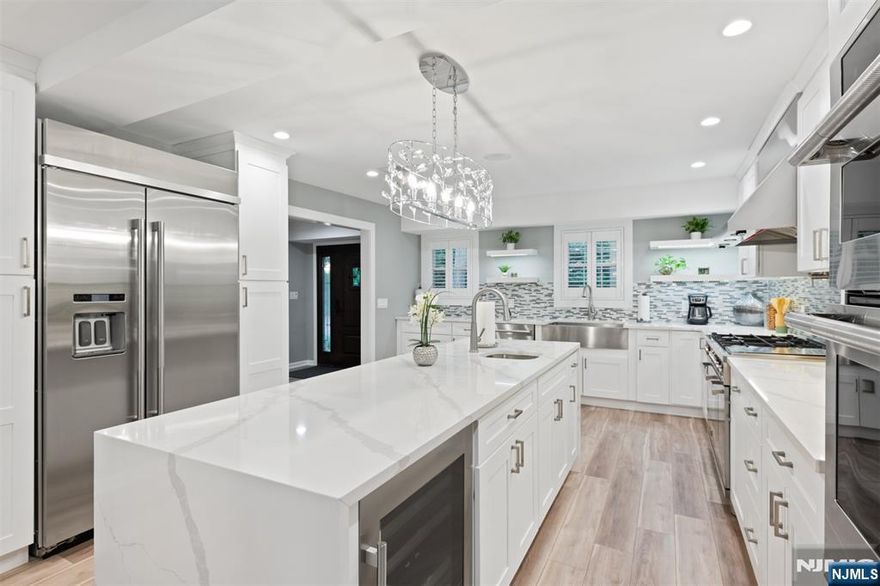 Pull into the oversized paved driveway and view the inviting wraparound porch â€” youâ€™ll instantly feel at home. This fully renovated split-level colonial offers over 3,600 sq. ft. of living space on nearly one acre, combining modern luxury with timeless charm. Inside, enjoy 5 spacious bedrooms including two primary suitesâ€”one with dual walk-in closets and a private balcony overlooking the backyard. The home features 3.5 beautifully updated bathrooms, generous closet space, and a flowing layout perfect for entertaining. The chefâ€™s kitchen boasts a waterfall quartz island, Bertazzoni appliances, and French doors opening to a tiered deck and private yard. Gather by one of two fireplaces in the living or game room, or spend summer days relaxing by the in-ground pool surrounded by pavers. With professional landscaping, elegant finishes, and a serene yet convenient location, this home is truly move-in ready. No flood insurance currently required (buyer to verify). Unpack and start living the River Vale lifestyle!