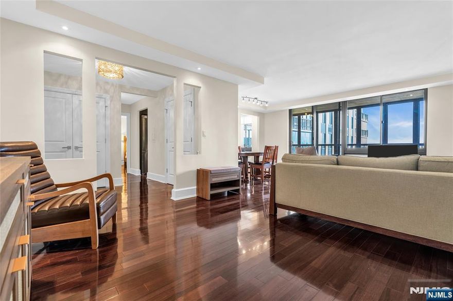 Welcome to this newly painted high-rise condo featuring brand-new lighting, a spacious foyer with a large closets, and an inviting open-concept living and dining area. Enjoy a private balcony with views of New York City and the Hudson River, the perfect place to unwind. The home offers a lovely eat-in kitchen, a bright and functional layout, and great convenience for commuting to NYC. The owner currently pays $116 for two parking spaces, with additional outdoor parking available (subject to availability). This wonderful community features top-tier amenities including an outdoor pool, playground, and tennis courts. Ideally located near shopping, dining, and more - this condo truly offers comfort, convenience, and an unbeatable view. Extra storage space on the same Fl.