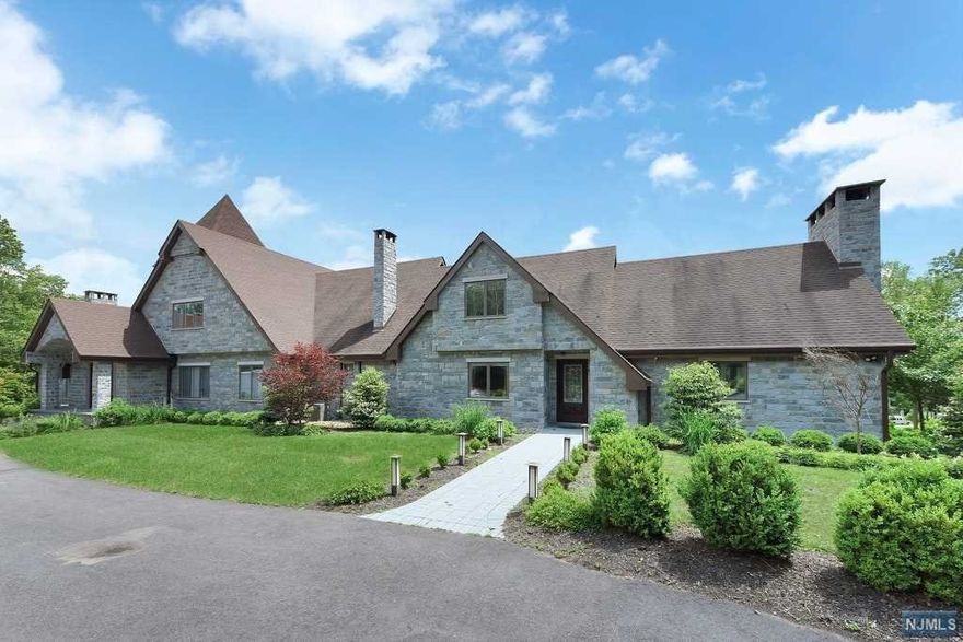 Welcome to this incredible estate set back on a mile long private driveway on approximately 22 acres. This home features 5 bedrooms, 4 full baths and 1 powder room all renovated with top of the line fixtures and finishes. Enter through the impressive foyer featuring an imported crystal chandelier, sweeping staircase and stone tile flooring to find large entertaining areas, 2 modern eat-in kitchens, a master suite with luxurious master bath and so much more. The great room with stone fireplace boasts a cathedral ceiling. Both kitchens are complete with stainless steel appliances and granite countertops. Full, finished lower level has an exercise room, billiard room, wet bar with granite countertop, large wine cellar and a full workshop, as well as access to the oversized 4 car garage. This home is truly a must see!