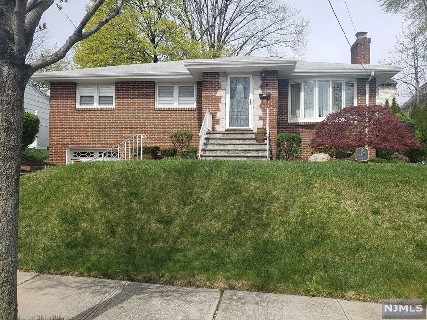 Well maintained move in ready custom built ranch style home with brick front, one car attached garage and a beautiful view of NY and the Empire State Building as well as the sunrise. Large living room with fireplace leading into a very large country kitchen. The home includes a large master bedroom, two additional bedrooms as well as a very large bathroom. Lots of closet space. The living room as well as the bedroom rooms all have the original hardwood floors and the kitchen has updated hardwood. The kitchen overlooks a beautiful patio in the backyard for summer entertainment. Wood-Ridge is a fabulous place to live and is about 1 square mile in size with an excellent school system. Anything that you might need is basically very close, schools, shopping. Minutes to bus and train for commute to NYC. Wood-Ridge is a lovely town to reside in.