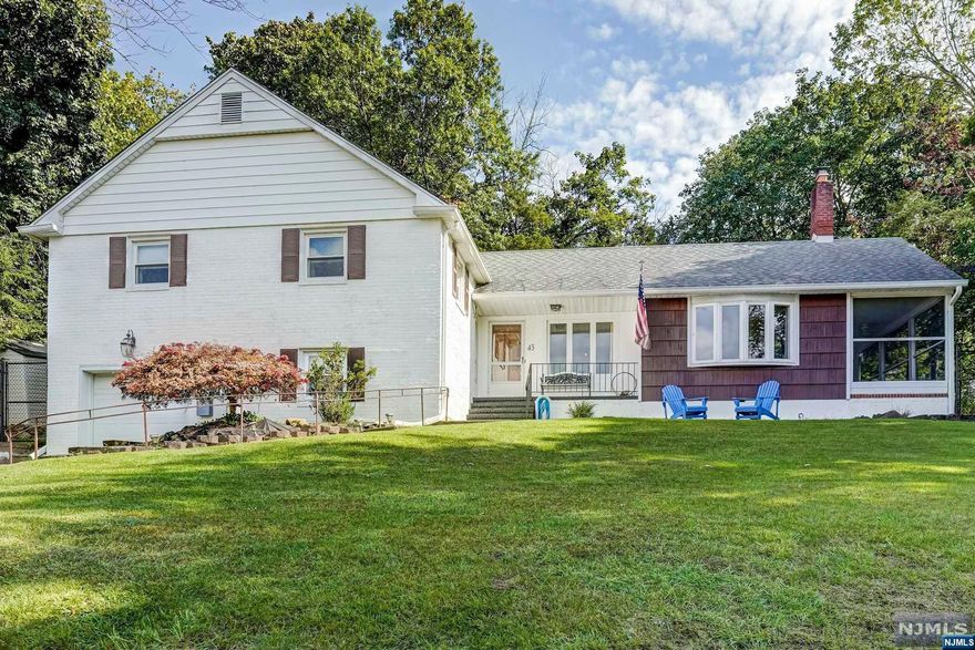 Located in the desirable section of Packanack Lake, this spacious split level is the home you've been waiting for. First floor main living space seamlessly connects the living room to the dining area & updated kitchen, making it an ideal layout for entertaining. The large windows in the living room provide abundant sunlight, & the stone fireplace will leave you warm and cozy all winter long. Make your way to the screened-in porch which is the perfect place to enjoy morning coffee or relax on a cool autumn night. The second level offers 3 large bedrms featuring a primary suite, & main bath w/new vanity. There's hardwood flooring throughout most of the home. The lower level includes a finished room that could be used as a 4th bedroom, office or den. Also located on this level is the laundry room, an oversized crawl space for storage & garage entrance. Sliding glass doors from the dining area lead you to the outdoor deck, overlooking the private fenced-in yard with mature trees.