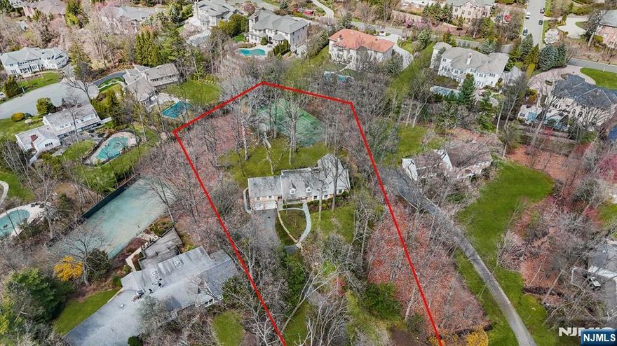 A rare opportunity in Tenaflys prestigious East Hill, this 6 bedrooms, 4 full baths and 2 half baths Center Hall Colonial sits on a lush, private 1.55 acre cul de sac lot with southern exposure and approximately 4,532 sq ft of living space. Custom built in 1958 and lovingly maintained by the same family, the home is set far back from the road, offering unmatched serenity and one of the areas few full size tennis courts. With a spacious 1st floor layout including bedrooms and baths, plus additional bedrooms upstairs and expandable attic space, the home offers incredible flexibility to reimagine and modernize. Youll feel 100 miles away yet youre just 6 miles from the GWB, in one of NJs most sought after towns with top rated public schools. This is more than a home its a lifestyle, a setting, and a chance to create something truly special. A unique opportunity for privacy, space and future vision. Come grab it.