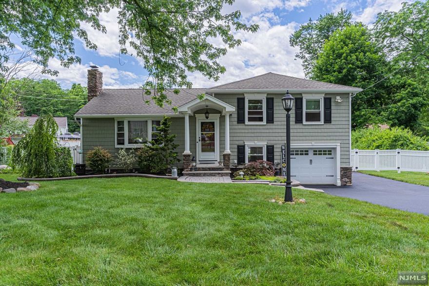 WOW! WOW! WOW! This home boasts true owners' pride! It's all in the details! Nothing to do but drop your bags: NEW AC! NEW driveway! Newer roof, vinyl siding & HW heater. Paver walkway leads to home and wraps around to fenced in, level backyard with great entertaining space: paver patio, spacious deck w benches, IG sprinklers, shed and railroad area for swing set/firepit/garden. Renovated white kitchen with quartz , SS appliances, peninsula & separate dining area, sliders to backyard! Spacious living room with a stone fireplace! Gorgeous baths with new tile+! Enjoy a great family room & office/den in the finished basement with a custom closet, laundry room & utilities ! Lots of parking, near schools(2 walkable in neighborhood), transportation & more! Hardwood floors or newer w/w carpeting mostly throughout! Plus enjoy all that Wayne offers: excellent schools(WHHS, AP Terhune, SCMS), Trader Joe's, Whole Foods, Boys & Girls Club, Y, PAL, James Roe Pool & more!