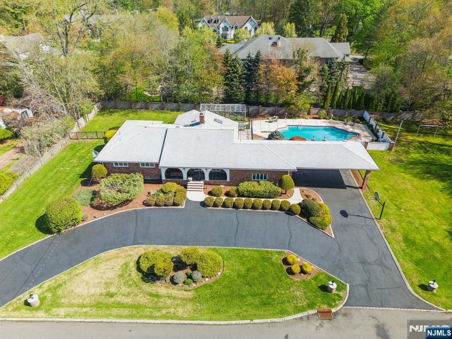 Ideally positioned on the coveted East Hill, this expansive ranch offers a California-inspired lifestyle defined by an open, light-filled layout and a relaxed yet refined feel throughout. The heart of the home is a sleek, high-end chefâ€™s kitchen, renovated in a modern European style, featuring a large seated island and seamless flow into the family room, with direct access to a wraparound terraceâ€”perfect for indoor-outdoor enjoyment. The main level offers 3 bedrooms, including a primary suite with a boutique-style custom closet and private bath. The expansive lower level features a large rec room, two additional rooms, a full summer kitchen, and full bath. Outdoors, enjoy a heated Gunite pool, garden enclosure, and cabana-style full bath. A circular driveway, garage, and 3-car carport complete this unique offering, just moments from shopping and major commuter routes. Incredible opportunity to live in desirable Upper Saddle River.