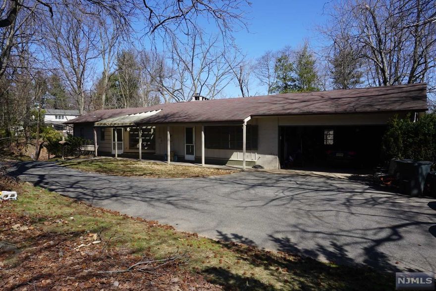 Welcome to this inviting private ranch that sits on half an acre above the reservoir. As you walk throughout, you will notice the great natural sunlight beaming through the large windows. Features include recessed lighting, gorgeous hardwood floors, owners suite and large wood burning fireplace! New furnace, condenser, and panel. Enjoy the patio space and large yard that wraps around the home. Two car garage and extra parking space. Close proximity to NYC train and bus. One of the best school systems in Bergen County.