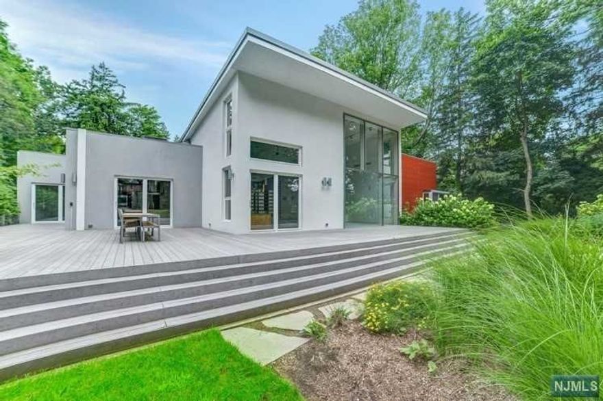 An architectural dream built with one central concept 'togetherness'. Walk right into the breathtaking open space with large windows filling the home with natural light that gleams off the beautiful large European tiled, radiant heated floors throughout. Custom-built in 2009 from the finest top of the line materials, complete with a gourmet kitchen where every inch of it is purposeful. The Play area is separated by a unique structure that allows for a cozy spot within the large space. This magnificent home offers approximately 6500sqft of one floor living is located on the east hill of Tenafly, minutes from Manhattan, and very close to Tenafly's lavish downtown area. This unique home is situated on 0.84 of property, where you will find elegance, privacy and sophistication combined surrounding an inground pool and is AVAILABLE FOR THE INDIVIDUAL WHO WILL SETTLE FOR NOTHING LESS THAN THE BEST!!!