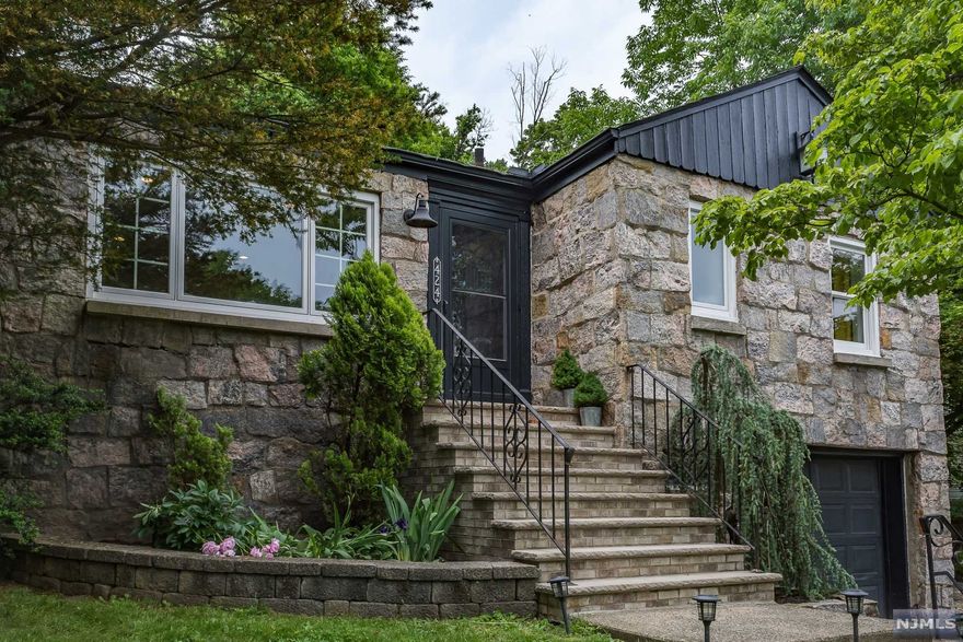 Modern styling meets classic charm in this stunning raised ranch. Be prepared to fall in love with all this house has to offer. Highlights include beautiful stonework on the exterior facade, an inviting gas fireplace and hardwood floors. The main level features your living room, dining room, kitchen along with a full bathroom and 3 bedrooms. The newly renovated lower level has a perfect home office, a full bathroom, and a large den. The backyard is your own personal oasis, complete with delightful landscaping and chic stone patio. Convenient location gives easy access to shops, restaurants, and NYC Bus. Walking distance to Cedar Grove Park. Truly a must see!