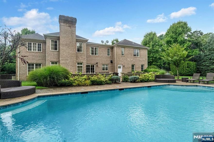 Stunning custom home in highly coveted Demarest that has been meticulously maintained. Extremely comfortable floor plan with 6 bedrooms, 5 full bathrooms, & 2 half bathrooms. Grand 2 story foyer with designer wall coverings greets you upon entry. Beautiful marble & tile throughout. Classic layout with large banquet sized formal DR. Continue along to the gourmet kitchen w. professional grade Wolf & Sub-Zero appliances, granite counters & huge center island. SGD off of the kitchen lead to the resort style backyard oasis with grand terraces, huge pool & spa with waterfall, outdoor kitchen, Bellagio style fountain, immense privacy & lush landscaping. Large living room & bonus room that would make an ideal home office/den. The 2nd level offers massive bedroom suites w. gorgeous bathrooms & huge closets. The primary features custom California WICs. Fully finished basement w. bedroom, theater, & large rec spaces. Freshly painted, 3 car garage, paver driveway, spectacular curb appeal!