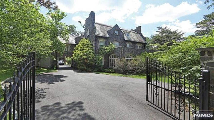 This grand estate sprawls across 1.65 acres in Englewood's coveted East Hill Section. Just minutes from the GWB and NYC, it comprises 3 extraordinary buildings: the main house, carriage house, and pool house. With over 12,000sqft, it features 8 bedrooms, 6 full and 2 half bathrooms, formal living and dining rooms, office/library, sunroom, gut renovated modern eat in kitchen with white quartz countertops, double ovens, two dishwashers, butler's pantry, and 5 fireplaces across three levels. All new Pella windows installed in 2023. The spacious carriage house with an atrium adds 5 bedrooms & 4 bathrooms in 2 separate living spaces, each with a living room & kitchen. An expansive indoor swimming pool enclosed for year-round use adds to the opulence. A 3-car garage is attached to the carriage house. Rich in character, this estate has captivated society's elite for generations