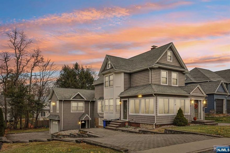 Beautifully renovated & expanded 2-family home in Park Ridge, move-in ready w/ modern updates and timeless charm. The first floor features a wraparound porch w/ slate flooring, a sitting room w/ a coat closet, a living room with a gas insert fireplace that can be converted into a wood-burning , and a dining room. The custom kitchen boasts Salerno cabinets, quartz countertops, top-of-the-line appliances. The first floor also includes two bedrooms, hardwood floors throughout, a spa-like bath with a walk-in steam shower. The lower level offers one bedroom, a full bath, kitchen, fireplace, living area, radiant heated floors, and one-car garage. The second floor features two bedrooms, a full bath, and a modern kitchen, perfect for rental income. Exterior highlights include two paver-heated driveways, a large backyard with a hot tub & gas grill. Close proximity to NYC public transportation. This home blends style, comfort, and convenience for the perfect living experience!