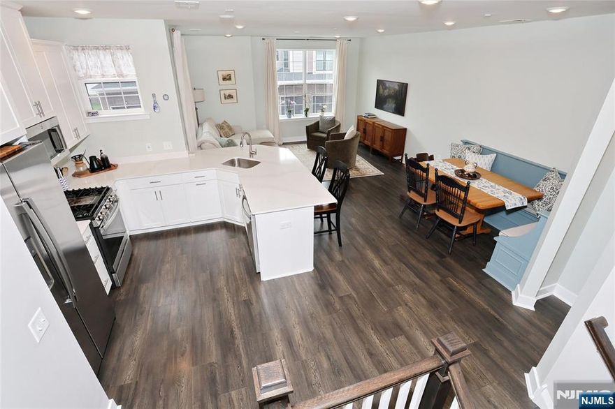 Welcome to The PARKE where carefree and maintenance free living begins. This Hampton model offers 2042 square feet of living space featuring an open concept living and dining area, kitchen with stainless appliances and quartz countertops as well as a pantry and powder room on the main level. The primary bedroom with ensuite, 2 additional bedrooms, another full bath, laundry and a great flex space are all located on the second level. The custom built in seating in the dining area has extra storage and the custom blinds make this unit ready to move right in. The spacious garage can accommodate a vehicle and storage and is equipped with an EV charging outlet. Little Falls is centrally located near transportation to NYC, great restaurants and tons of shopping. This beautifully maintained unit is a must see !