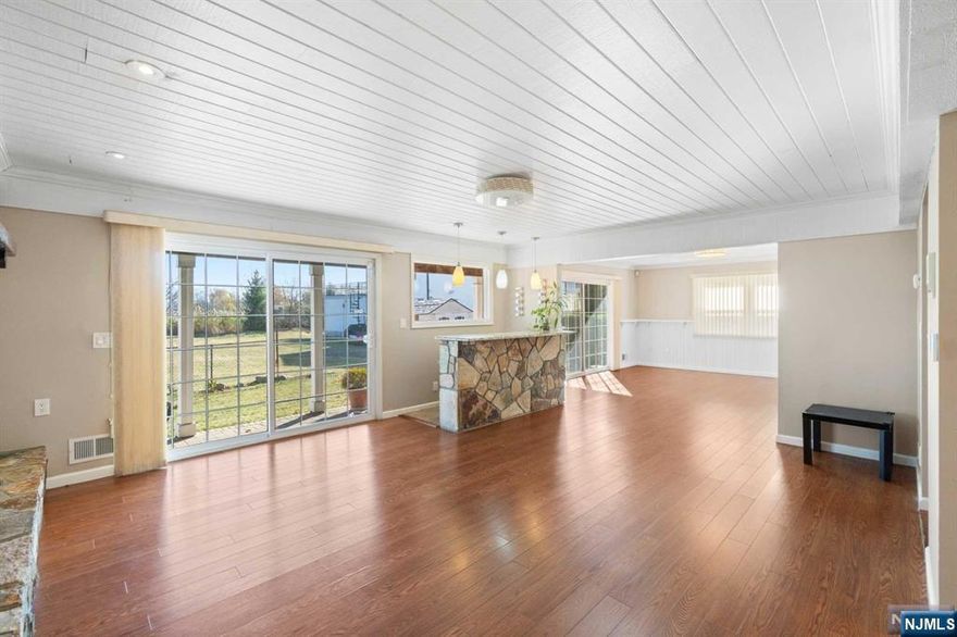 Nestled on a quiet street in Secaucus, this 5 bed, 5 bath colonial home w 2,900 sq. ft. is sure to impress. Wake up to breathtaking sunrises over the city skyline & serene meadows. Inside, the family room features a stone-faced wood-burning fireplace and a wet bar w sliding doors opening to the patio, perfect for entertaining. The large kitchen features a center island, granite counters, abundant cabinet space, & stainless appliances.. Each bedroom has an ensuite, ensuring comfort for all. The primary suite is a true oasis, complete w a large deck, & ensuite with a jacuzzi tub & sauna. Double-paned windows throughout the home invite natural light while maintaining energy efficiency. Add'l features include central HVAC, a 10-year-old roof, & water heater for ultimate energy efficiency. Outside, a half-circle driveway offers parking for up to four vehicles. Don't miss the opportunity to make it your own!