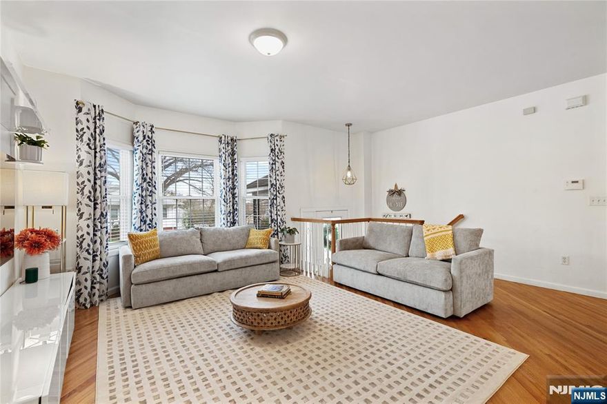 Built in 2009, this beautifully maintained 2,497+ sq ft home blends timeless design with modern comfort. Hardwood floors run throughout, creating a warm, cohesive feel, while the oversized private patio and backyard offer the perfect setting for summer gatherings or quiet evenings outdoors. The main level features a bright, open-concept layout, seamlessly connecting the sun-filled living room, dining area, and kitchenâ€”ideal for both everyday living and entertaining. The kitchen includes updated stainless-steel appliances, along with thoughtful upgrades such as a full-house water filtration system with reverse osmosis, energy-efficient LED lighting, and a dual-zone heating and cooling system for enhanced comfort year-round. Upstairs, the spacious primary suite features an en-suite bath, along with two additional bedrooms perfect for family or guests. The third level offers a versatile loft-style den, ideal as a home office, media room, or private retreat. The fully finished basement with half bath adds flexibility and can easily serve as a guest suite, family room, or playroom. Ideally located near schools, parks, shopping, and easy access to direct NYC bus service, this home offers both convenience and comfort in a highly desirable location.