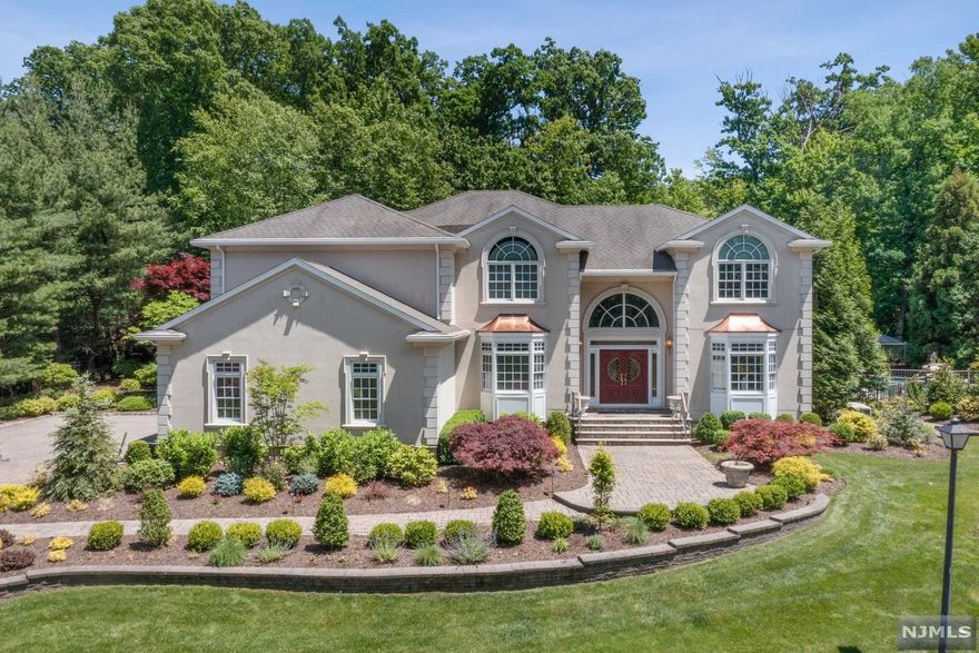 Custom home offers exceptionally large entertaining spaces set on a park-like, private property. 2-story entry foyer w/curving staircase. Great Room has 2-story Palladian windows, wet bar, hardwood floors, fireplace, 3 French doors & built-in media center. Huge chef's kitchen w/eat-in area that seats 10, 2 French Doors out to patios. Island w/2 sinks, breakfast bar seats 5. Top-of-the line appliances inc new (2022) Miele dishwasher, 6-burner Thermador stove w/grill, and double wall ovens. Formal DR w/built-in cabinetry flows to LR w/bay windows. 1st flr Office is ideal for WFH.. 2nd flr includes PBR w/sitting room, bedroom w/coffered ceiling & spa-like bath. 3 add'l BR's, 2 full bths on this level. Spacious LL features game rms, exercise rms, playrm, wet bar, media area and more. Outdoor delights inc paver patios, bult-in grill area, freeform heated, saltwater pool w/spa and waterfall. 3-car garage with car lift and radiant heat floors throughout.