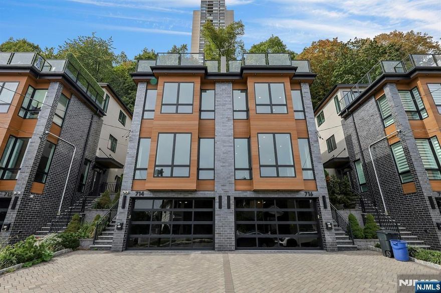 EXPERIENCE ELEVATED LUXURY FOUR-STORY TOWNHOME, WHERE REFINED ARCHITECTURE MEETS BREATHTAKING, UNOBSTRUCTED VIEWS OF THE NYC SKYLINE,HUDSON RIVER, AND THE GW BRIDGE.THIS EXCEPTIONAL RESIDENCE BOASTS 9-10 HIGH CEILINGS,EXQUISITE FINISHES,AND 5 BED.5 BATH OFFERING BOTH SOPHISTICATION & COMFORT.THOUGHFUL DESIGN ACROSS EVERY LEVEL.THE GROUND LEVEL WELCOMES YOU W A PRIVATE BEDRM W FULL BATH, GENEROUS STORAGE,A VERSATILE BONUS SPACE-PERFECTLY SUITED FOR A HOME OFFICE,FITNESS STUDIO,OR PRIVATE LOUNGE.THE MAIN LEVEL SHOWCASES AN OPEN FLOOR LAYOUT W FLOOR-TO-CEILING WINDOWS FRAMING ICONIC CITY VIEWS.IT INCLUDES A BRIGHT LIVING RM W A COZY FIREPLACE,A FORMAL DINING AREA,AN EAT-IN GOURMET KITCHEN FEATURING AN OVERSIZED QUARTZ ISLAND.HIGH-END MIELE APLIANCES, AND A CONVENIENT POWDER RM.GLASS AND METAL RAILINGS ENHANCE THE HOME'S CONTEMPORARY ASETHETICS.THE THIRD FLOOR OFFERS A LUXURIOUS PRIMARY SUITE W DOUBLE DOORS,EXPANSIVE WINDOWS OVERLOOKING NYC SKYLINES,A SPA-INSPIRED BATH W JACUZZI TUB.GLASS-ENCLOSED SHOWER,MARBLE DOUBLE VANITY.TWO ADDITIONAL GENEROUSLY SIZED BEDRMS,A FULL BATH,A LAUNDRY RM PROVIDE COMFORT AND CONVENIENCE.ONE BEDRM OPENS TO A PRIVATE BACKYARD, PERFECT FOR PATIO SETUP OR HOT TUB.THE TOP FL IS DESIGNED FOR ENTERTAINING,FEATURING A SUN-FILLED LIVING RM W SKYLIGHTS,A BUTLER'S KITCHEN,DIRECT ACCESS TO A LARGE,PRIVATE ROOTTOP TERRACE OFFERING SPECTACULAR MILLION-DOLLAR VIEWS.THIS LEVEL ALSO INCLUDES AN JUNIOR MASTERBEDRM W SKYLIGHTS,MULTIPLE WALK-IN CLOSETS,A FULL BATH.