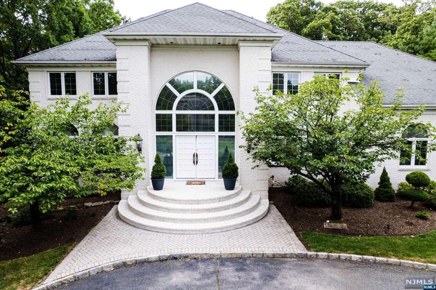 Magnificent home is nestled in a small sought-after subdivision in the heart of Livingston, NJ. (45mins outside of NYC via bus to Port Authority Station or Newark Train Station) The home is beautifully constructed of white brick and a grand semicircle frontal stoop with an elegant semicircular driveway. French door entry way and a two-story marbled foyer area. Main floor consists of a well-lit great room, a living room with elegant fireplace and dining room. The great room has light-stained hardwood floors and Two Palladian windows. A chef's kitchen complete with GE appliances, a subzero refrigerator,2 additional freezer drawers. The second floor has a mirrored master bedroom with 2 larges walk in closets. The master bath includes large jacuzzi tub, steam shower and bidet. There are 3 additional bedrooms, 2 bathrooms and Den/Playroom area all on the 2nd level. Basement level has large multipurpose room and colossal utility room and guest bedroom and one full bath