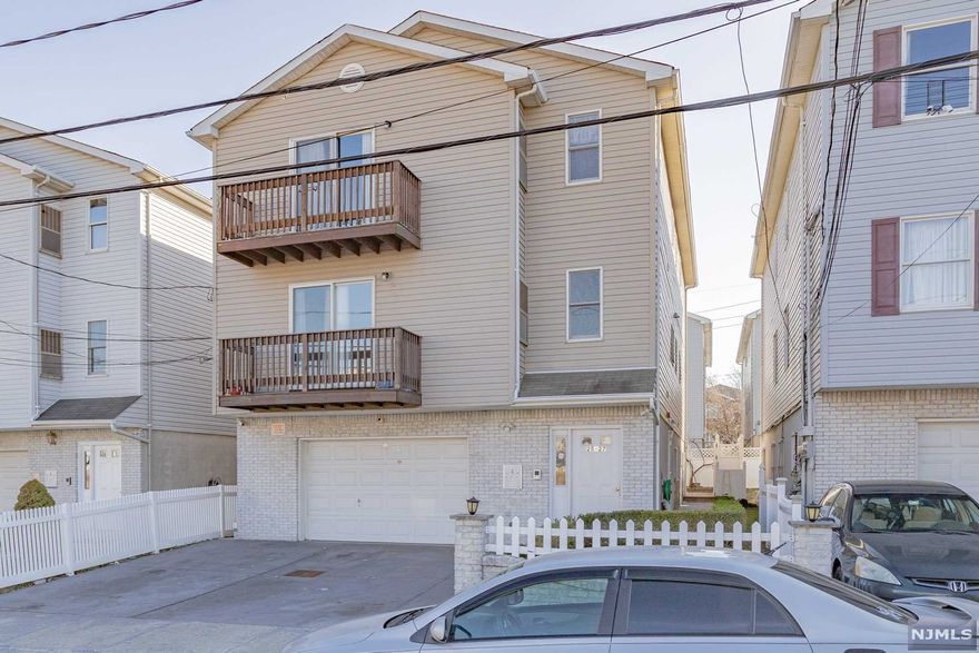 WELCOME TO THIS RARE INVESTMENT OPPORTUNITY!!! Newer large three-family home in excellent condition located in the desirable section of the Ironbound, features Kitchen, living room/Dining room, three spacious bedrooms per apartment and two full baths laundry room hardwood & carpet floors throughout lots of Storage space. Brick front with Balconies, built-in two-car garage, and Driveway for two cars, Near recreation Parks, Public transportation, and all major Highways. High rental income