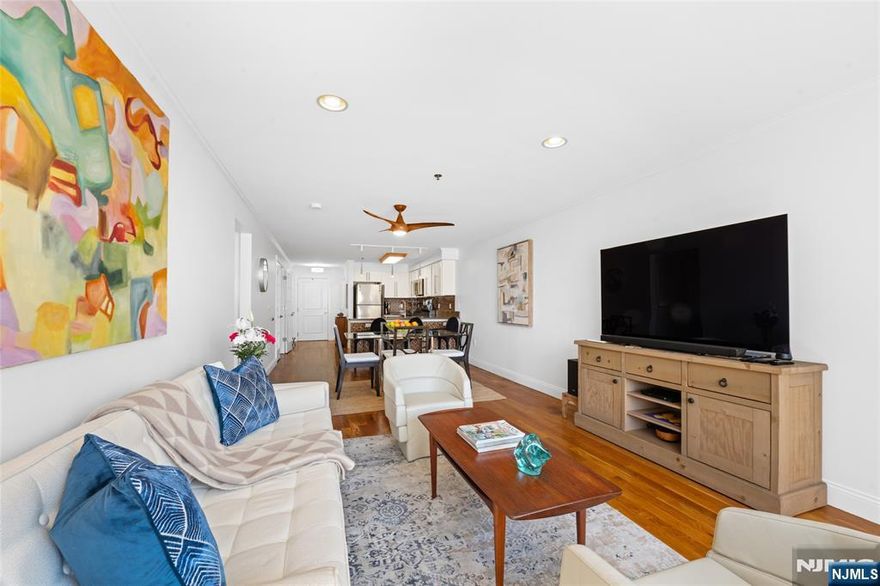 Experience the perfect harmony of space and style in this expansive 1-bedroom plus den residence. Spanning 993 square feet of meticulously maintained living space, this 2008-built condo offers a modern sanctuary in the vibrant heart of West New York. The bright, open-concept floor plan is anchored by gleaming hardwood floors, creating an inviting atmosphere for both relaxation and entertaining. Featuring premium stainless steel appliances and a seamless transition into the dining and living areas. A versatile secondary room serves as the ideal professional home office, creative studio, or guest accommodations. Enjoy a fully renovated bathroom and the indispensable convenience of an in-unit washer and dryer. Includes a highly coveted 1-car garage space, providing easy access. Situated in a well-maintained elevator building featuring a DoorBird intercom system. Enjoy proximity to local schools and parks, with shopping and dining nearby. Access to both bus and Hudson Bergen Light Rail, ensuring a simple commute to NYC. Discover your new home today, schedule a private viewing to experience this West New York standout.