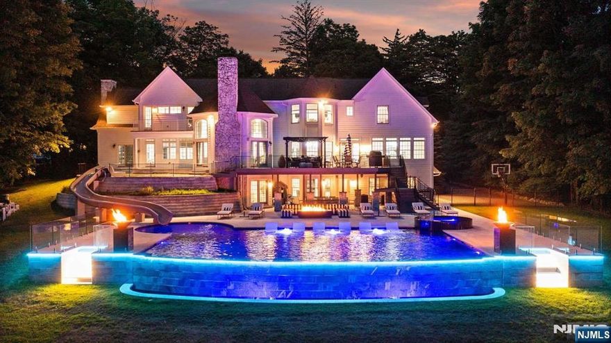 Welcome to MONT ESCAPE, where enchantment meets luxury. Immerse yourself in the sanctuary of this true resort-style backyard featuring a magnificent 2,500 sqft saltwater, negative edge pool & spa with a 40 ft cascading water slide! A recent full renovation has elevated this majestic 10,000 sf, 7-bedroom estate to new heights. Nestled on a serene, rare 1.9-acre lot loaded w privacy, the circular driveway leads you to an opulent 2-story entry foyer with Italian porcelain floors. The magnificent great room boasts a custom fireplace & large bright windows. A chef's culinary kitchen, formal dining room, piano room, office, bed & more grace the entire first floor. The second floor features an oversized primary suite w 2 WICs & a Juliet balcony overlooking the sprawling backyard oasis. The lower level offers space for extended family with a bedroom, full bath, living area, kitchen, gym, & rec area. Luxury & sophistication intertwine to create your dream escape, just 28 miles from NYC