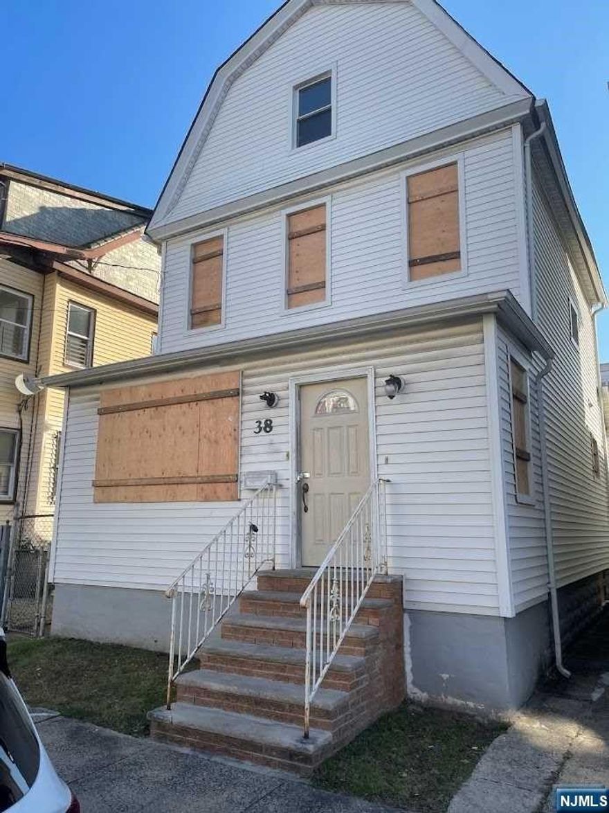 Updated Kitchen & Baths. Needs TLC. Deck off of kitchen to nice backyard. Third floor large room could be used as a playroom or master bedroom. Stainless steel appliances and wood floors throughout.