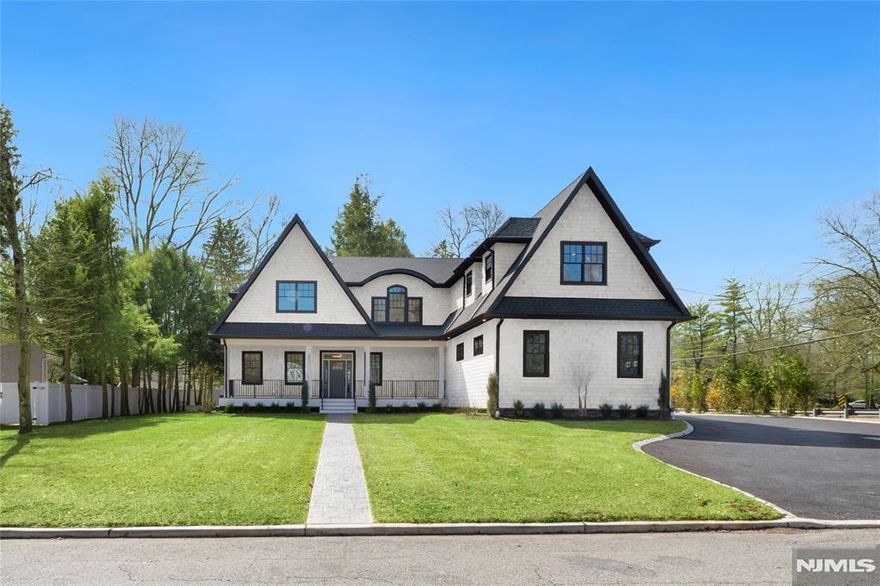 Set in the heart of River Vale, New Jersey, 803 Marshall Road presents a one-of-a-kind new construction defined by bold design and elevated craftsmanship. From the moment you arrive, the home impresses with striking curb appeal and a thoughtfully designed exterior. Inside, white oak flooring and abundant natural light complement soaring 10-foot ceilings and an open, airy layout. The chef-inspired kitchen features a quartzite island, high-end appliances, a spacious pantry, and refined finishes. A rotunda-style dining area offers sunset views, while a 25-foot sliding glass door creates seamless indoor-outdoor living, opening to an expansive deck. The main level includes a bedroom, office, and two full bathrooms, offering flexible living options. Upstairs, the primary suite features coffered ceilings, a custom walk-in closet, and a spa-like bathroom. Three additional en-suite bedrooms and a bonus room provide versatility for a variety of uses. The lower level offers approximately 2,500 sq ft with high ceilings, ready to be customized. Conveniently located near parks, shopping, and transportation, this home offers a rare opportunity in Bergen County.