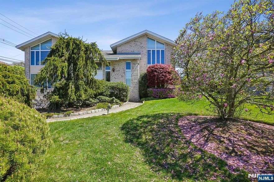 Experience timeless elegance in this custom brick and stucco Center Hall Colonial, built in 1993 and located in prestigious Englewood Cliffs. This elegant home features grand-scale rooms, oversized windows, vaulted ceilings, skylights, and beautiful hardwood floors. The main level offers a dramatic double-height foyer, formal living and dining rooms, a center island kitchen, a sunlit great room with fireplace, library, and powder room. Upstairs, the expansive primary suite boasts vaulted ceilings and a luxurious marble bath, along with three additional bedrooms and two full baths. The finished lower level includes generous recreation space, a bonus room with full bath, and a separate office suite with its own entrance, reception area, and multiple exam roomsâ€”ideal for professional use. With low taxes and close proximity to NYC transportation and major highways, this home offers exceptional value in one of Bergen Countyâ€™s most desirable locations.