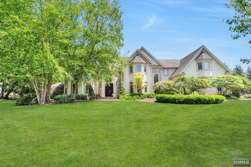 Located on a beautiful multi-million dollar cul-de-sac, this timeless colonial offers 3 floors of magnificent living with a desirable open floor plan and quality tailored millwork throughout. The spectacular two-story foyer greets you upon entering the home. Relax in the spacious living/family room which features floor-to-ceiling windows, a gas fireplace, and French doors that exit to the expansive patio. The designer white kitchen sparkles and opens to a second family room with vaulted ceiling and another fireplace. On the first floor is a spacious guest suite or office. An additional 5 bedrooms upstairs include the impressive primary suite with a spa-like bath, steam shower, whirlpool tub, several closets & balcony overlooking the lush yard. Unwind in the lower level with a media room, wine room, gym area, open recreation space, and tons of storage. Enjoy your outdoor kitchen and back patio, perfect for alfresco dining and gathering with guests in your private fenced backyard.