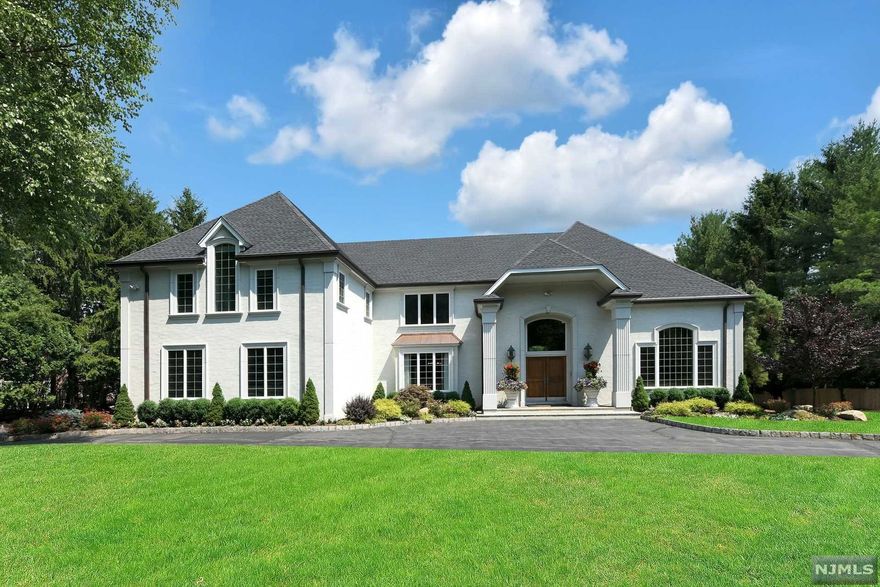 Welcome to this custom built 6 bedroom, 5 full and 1 half bathroom, Center Hall Colonial located on one of Upper Saddle River's most desirable cul-de-sacs. Experience private resort living with the meticulously manicured grounds, multi-level deck and Gunite swimming pool. Features of this one-of-a-kind home include a circular driveway, 4-car garage, hard mason stucco exterior and a newer roof. Enter through the grand entry foyer to immediately experience this home's quality craftsmanship and attention to detail, including custom woodwork, 2-story great room, formal living room, spacious eat-in kitchen with walk-in pantry, separate butler's pantry leading to the formal dining room and a first floor guest bedroom suite. The second floor Master Bedroom Suite is truly spectacular with a private sitting room and balcony overlooking the backyard. The walk-out basement is filled with natural sunlight and leads to a rear patio. This home is truly a must see.