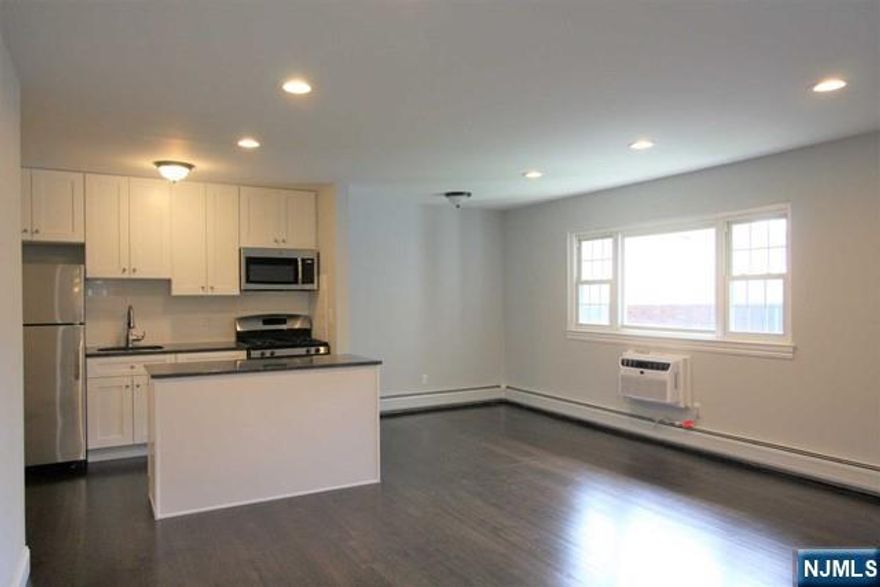 Renovated, Gorgeous and Very Spacious 2nd floor unit. NEWER White Kitchen, Soft-close Cabinets, Center Island,Granite Counters, Stainless Appliances, Hardwood Floors.Large Bedroom, NEWER Bath.Walk to Stores,Restaurants, NYC Transportation, Park,Walking Path,Houses of Worship and so much more.MOST UTILITIES INCLUDED! Heat,Water,hot-water,Gas for cooking are INCLUDED.One Assigned Parking Space Close to Unit,additional guest parking,Coin-0p Laundry in Basement. Storage Area in Basement.No Smoking/No Pets please don't ask.A Gem!