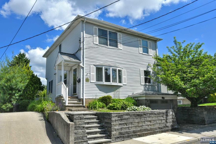 Welcome to this spacious, well maintained 3 bedroom, 2.5 bath colonial home in Hawthorne! With updates throughout, this house is sure to please. Upon entering the home, you are greeted by an open floor plan- featuring foyer entrance, large living room with wood burning stove, kitchen with breakfast bar & separate dining area, laundry room, rear foyer entrance with glass french doors leading to the rear deck, and powder room. The staircase to the second floor reveals a large primary bedroom & bath, 2 additional bedrooms with large closets, and another full bath. The basement level features a cozy family room & office area, utility room, direct garage entrance, and plenty of storage space. The exterior of the home features large rear deck overlooking the private yard, driveway, and attached 1 car garage. Other features of the home include central a/c, newer windows/roof/siding, multiple zone heat, and so much more. Perfectly priced, come see this beautiful house today! :)