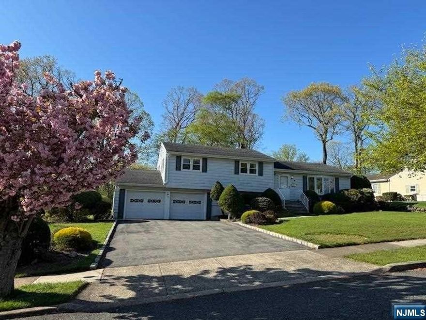 Well maintained 3 bedroom 2.5 bathroom Split level. Greet your guests into the entry foyer which leads into the living room featuring bay window & mirrored walls. Living room flows into the dining room which offers plenty of space to savor a quiet meal at home or entertain your guests. The dining room leads into the spacious family room offering fireplace, custom built-ins, skylight & large windows. Door from the family room leads onto the rear deck offering the perfect space for outdoor entertaining & grilling. The deck leads into the large rear yard offering ample space to enjoy all of your outdoor activities. Just off the family room is the kitchen featuring plenty of custom cabinetry and counterspace. Retreat upstairs to find the primary bedroom offering large closet & full bathroom complete with storage vanity & glass enclosure stall shower. The ground level offers den, laundry room with powder room & access to the 2 car-attached garage. Basement offers utilities and storage