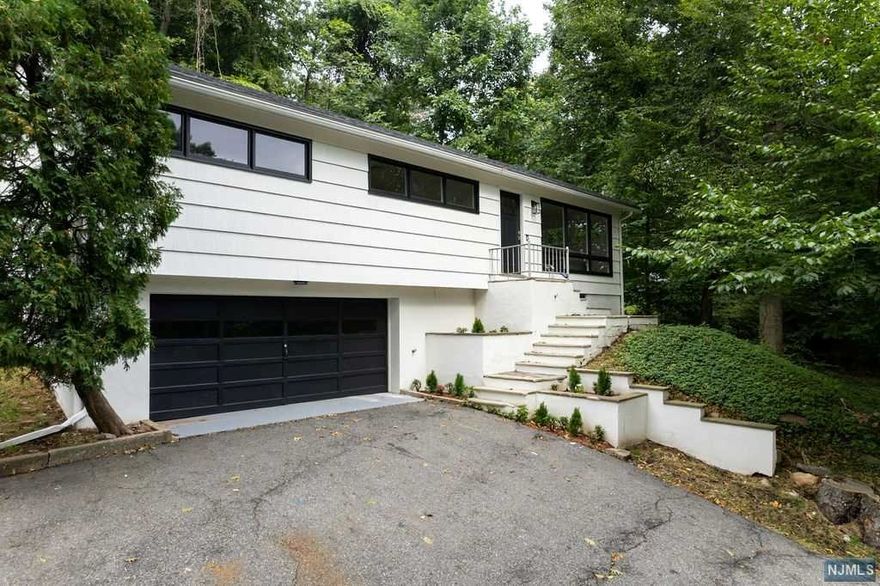 Stunning renovated ranch featuring a completely remodeled 3 bedroom 3 full bathroom open concept home. This home provides a designer style kitchen with quartz countertops, SS appliances, glass subway tile backsplash, recessed lighting, warm and inviting living room, spacious bedrooms, spa-like bathrooms and abundance of natural light throughout!! Lastly, a very spacious 2 car garage with laundry room, 3rd bedroom, full bathroom and utility room on ground level.