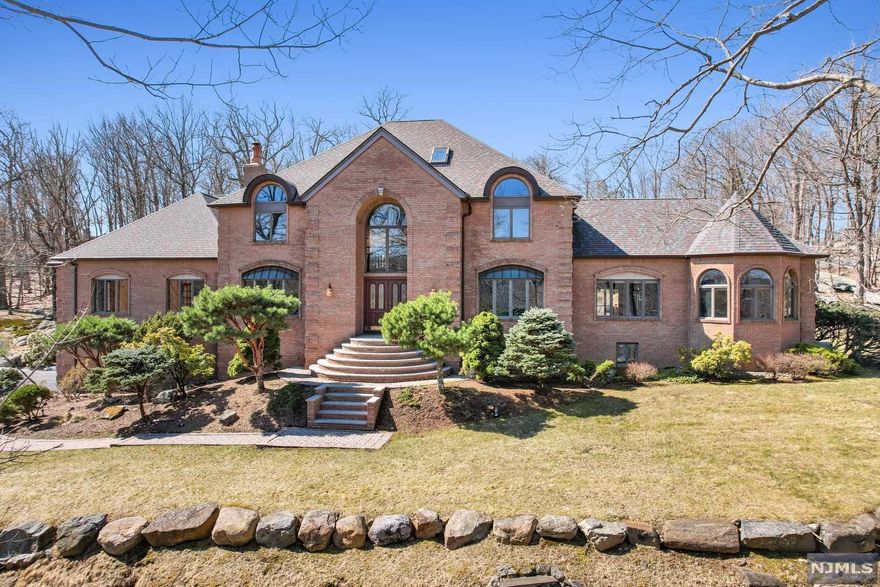 Get ready for summer with a Pool and lake views! This custom built home is located in Smoke Rise, a private gated community with 24/7 security and amenities. Nothing but high end materials were used on this home with quality construction. 2 story foyer with circular staircase open to large 2 story Great Room with floor to ceiling marble fireplace flanked by walls of glass, Formal Living Room, Formal Dining Room with marble fireplace, Kitchen has large center island and separate dining area which leads to additional Great Room with brick fireplace with built-in custom bookcases. First floor master bedroom with en suite custom onyx bath, Second floor catwalk over look Great room, Third floor has additional bedrooms /den and bath. In-ground cement pool & Trex decking with private backyard. Pristine landscaping. Roof only 3 years new! High ceilings, hardwood floors throughout. First floor master bedroom. Basement has indoor driving range and tennis practice wall.