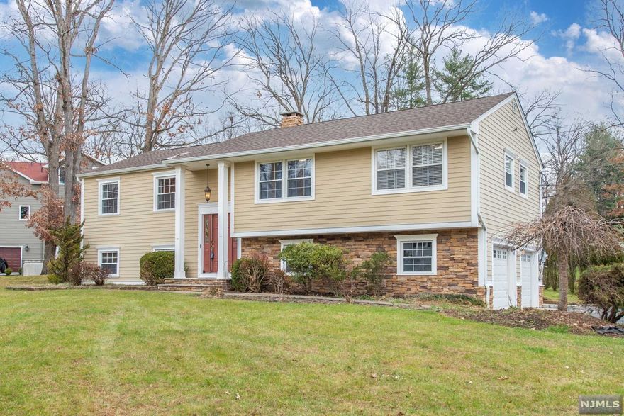 Beautiful 2,550 s.f. oversized 4 bedroom, 2 1/2 bath Bi-Level on a large corner property. The main level features 3 bedrooms & 2 FB, a spacious formal living & dining room with vaulted ceiling & updated eat-in-kitchen. The dining room & kitchen overlook the spacious great room down below. The primary bedroom has its own FB. The lower level features the 4th bedroom, powder room and a spacious great room with a dry bar, cathedral ceiling, skylights and two sets of sliders that go out to a patio overlooking a parklike setting. Perfect space for entertaining! New roof installed 3 months ago! Additional features include wood floors, a whole house generator, hardie plank siding, updated kitchen & main bath in 2018. Being sold AS-IS. No known defects.