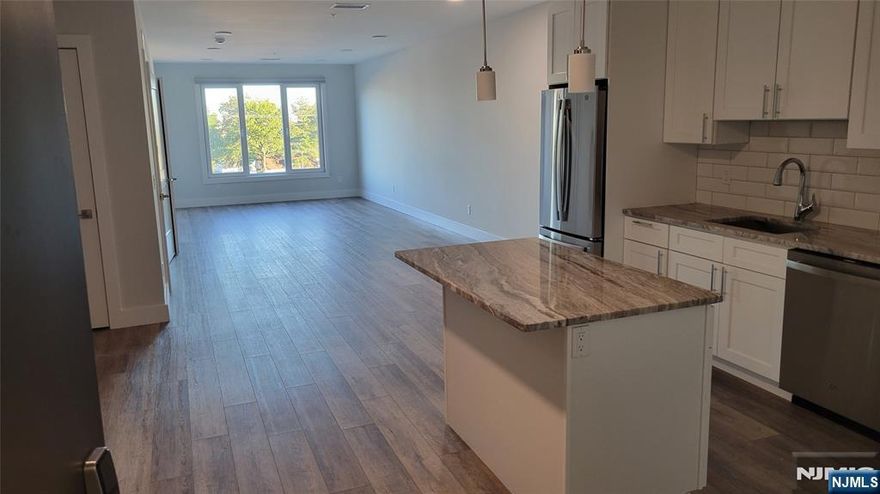 Experience modern luxury living in this brand-new, 1,216 square foot, one-bedroom apartment with a spacious den, perfectly located just one block from the Rutherford train station and bus stop. This elegant residence features a contemporary kitchen, open concept living room, and a large walk-in closet. Enjoy the convenience of an in-unit washer and dryer and the comfort of one assigned parking space in a secure garage. Residents also have exclusive access to premium amenities, including a state-of-the-art fitness center, peaceful yoga room, and inviting social lounge. Combining upscale finishes with unbeatable convenience, this apartment offers the perfect blend of style, comfort, and location. No Security Deposit required. NTN, credit check, renter's insurance required.