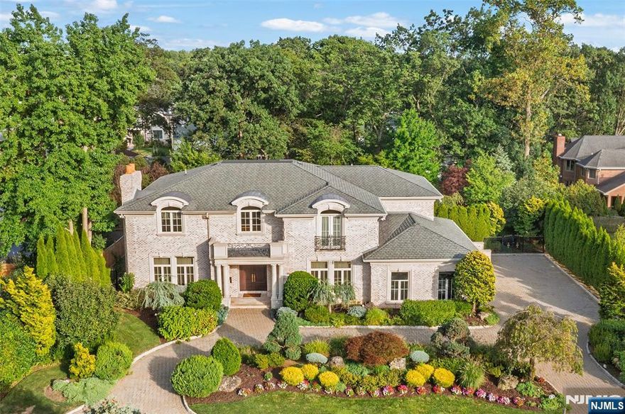 Experience unparalleled luxury in this meticulously crafted 5,400 sq. ft. custom-built estate featuring a robust poured concrete foundation. Set on a magnificent 18,000 sq. ft. lot, this architectural marvel spans three levels, offering a private oasis of quality and comfort. The home features 5 spacious bedrooms and 4.5 luxurious bathrooms. Soaring 10-foot ceilings throughout create grandeur, while a convenient in-home elevator provides effortless access to every floor. The heart of the home is the true gourmet kitchen, a culinary dream with exquisite Neff cabinetry, professional-grade Wolf cooktop, and double Sub-Zero refrigerators. Enjoy seamless comfort as radiant heat warms the grand foyer, kitchen, and a unique traditional Asia-inspired bedroom. Bathrooms are appointed with premium Waterworks fixtures and designer tiles. Advanced amenities ensure ultimate convenience and peace of mind, including a backup generator, driveway security sensor, and water softener system. Step outside to a completely private backyard sanctuary, the perfect backdrop for entertaining or unwinding. This residence is a testament to sophisticated, uncompromising luxury. Listing agent is related to seller.