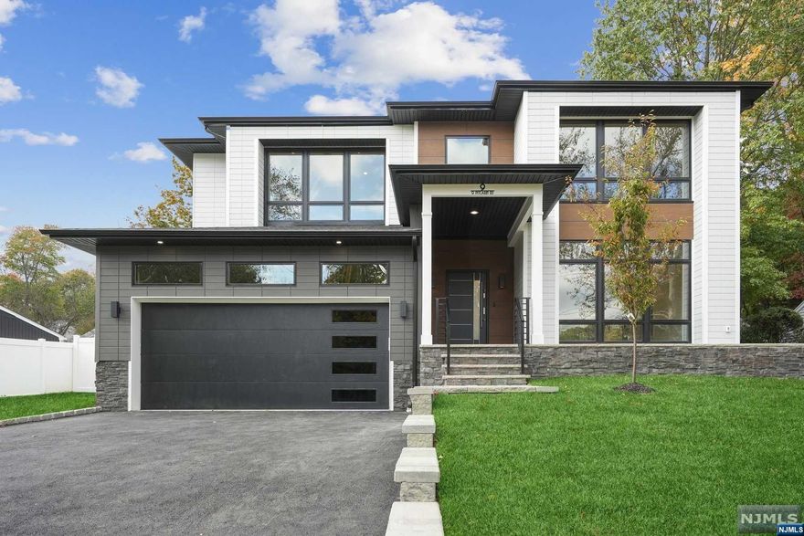 Brand New Construction by NJGCBCORP, a leader in Modern Architecture and Design. Sleek, Modern and Contemporary Finishes throughout this Custom Smart Home with over 4600 sq ft of livable finished space. An Impressive Home with Floor to Ceiling Oversized Windows, Modern Staircase and Open Concept Living. First Floor w/10ft Ceilings, Formal Living Rm, Dining Rm w/Butler's Pantry, Large Family Rm w/Gas FP, Sliders leading to Covered Patio. A beautifully appointed Chef's kitchen w/ High End SS App, Walk-in Pantry, Custom Cabinetry, Center Island w/Quartz Waterfall & Sliders leading to Stone Patio. First Floor Guest Suite with Bed & Bath. Mudroom & Powder Room.. Grand Primary Suite w/ Vaulted Ceilings, Magnificent Windows, Custom WIC's and Sliders leading to Sun Deck. Primary Spa Bath w/soaking tub, Dual Vanity and Heated Floors. Three large bedrooms, 2 full baths & Laundry Room complete 2nd Floor. Finished Walkout basement w/6th Bedroom, Bath, Media Rm, Rec Rm, Office.