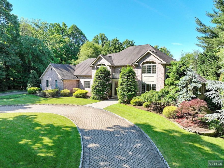 Embracing both beauty & elegance, this custom brick colonial on over 1 acre has everything the discerning buyer is looking for! The expansive paver circular driveway welcomes you into the sunlit 2 story entry w/a beautiful sweeping staircase. On the main level of this 5500sf home, the rooms seamlessly flow from one to the other with modern sensibility. The chefs kitchen is a cooks delight w/a 6 burner stove, double oven, huge center island, wine fridge & pantry. Off of the kitchen is the sunken F/R w/FPL & the frml D/R, along w/a 5th bdrm w/full bath-perfect for an au pair or guest quarters. A frml L/R, home office, 1/2 bath, laundry rm & an amazing bonus rm w/walls of windows is a terrific game room & completes the 1st lvl. Upstairs is the huge primary bdrm w/2 walk-in closets & a hotel-like primary bath. The 2nd bdrm has it own bath & the add'l 2 bdrms are joined w/a jack & jill bath. Another sunlit F/R completes the 2nd lvl. This is luxury living at its best-don't miss out!
