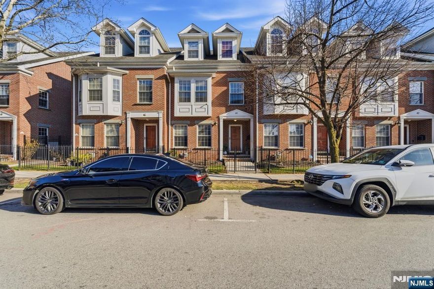 Spacious 3-bedroom, 2.5-bath townhouse offering a comfortable layout with great living space and many desirable features. The main level features an open floor plan with a bright living room, dining area, kitchen, primary suite, and convenient guest powder room, with newly replaced flooring throughout. The private main-level primary suite includes a large walk-in closet and a full bathroom with double sinks. The second floor offers a generously sized second bedroom with two closets and alcoves that provide additional flexible space for a sitting area or workspace, along with a third bedroom large enough for a queen-size bed and a full main bathroom. The ground level features a spacious, warm, and inviting family room, along with a laundry area and utility room. Additional highlights include a built-in two-car garage plus an assigned parking space and a privately gated front yard unique to this attractive complex. Conveniently located near shopping, restaurants, and the newly renovated ShopRite, with easy access to major highways, local bus service at the nearby corner, a short distance to the train with 7-day service to NYC, and just minutes from Newark Liberty International Airport.