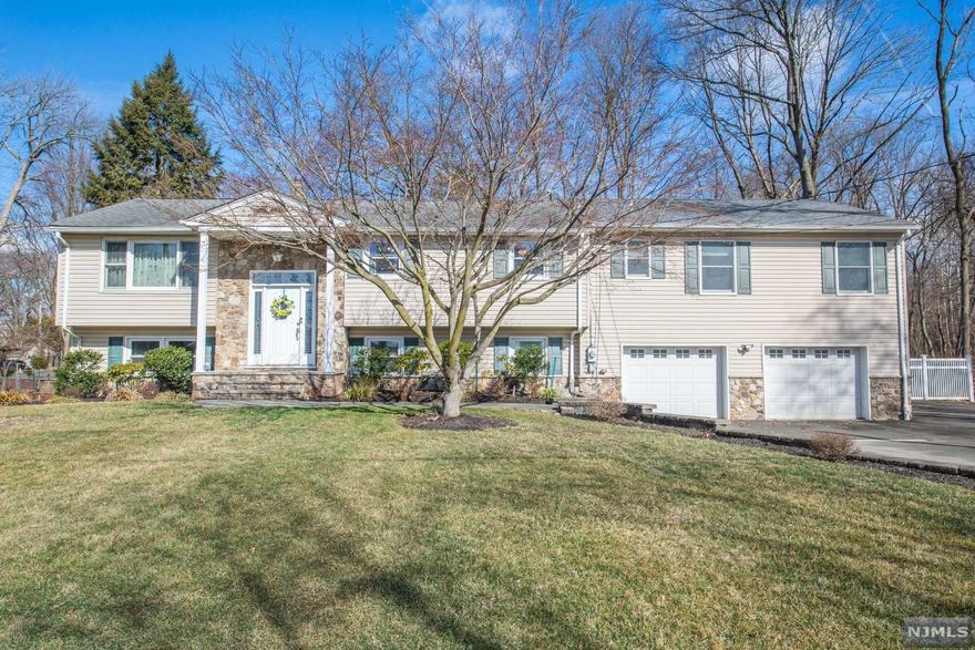 Looking for an amazing expanded bi-level...look no further! This home is SPACIOUS.... it features the main level with an updated kitchen , dining room with sliders to a beautiful deck, 3 bedrooms, a full bath and hardwood floors throughout. The lower level offers a spacious family room with vinyl laminate flooring, a full bath, 4th bedroom with carpet , laundry room and an extra room with countertops, sink table and chairs. Over the garage is an In-Law suite with a full kitchen, living room, full bath and two bedrooms with sliders to a deck. Completely fenced in, well manicured yard. This home boasts true pride of ownership....schedule your showing today it will not last!