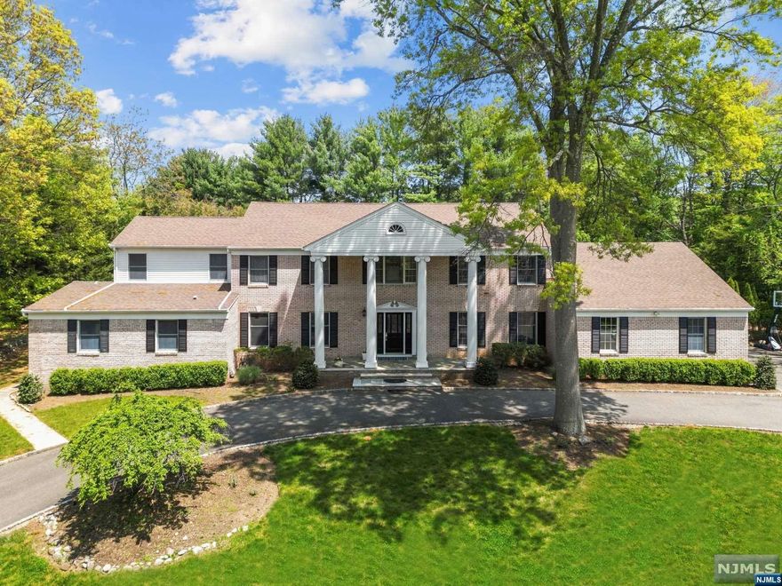 Luxury living awaits in this impressive Estate located in ultra-desirable Franklin Lakes. This Classic Center Hall Colonial sits majestically on 1-acre of flat property. 6 bedrooms & 4.5 bathrooms with over 5,000 sq ft of living space. Gorgeous in-ground pool & grounds surrounded by lush landscaping. Entire home has been recently renovated with designer finishes. Brand New Chef's kitchen features professional grade appliances & custom cabinetry w. quartz countertops. Stunning Great Room with dramatic stone fireplace & custom wet bar. 2 private guest wings on the main level each with private bathrooms. This home can accommodate guests comfortably or provide ample work-from-home space. Head upstairs to the sprawling primary retreat with a spa-like bathroom, sitting room, & dual W.I.C.'s. plus 3 additional spacious bedrooms & another brand new bath. Finished basement w. rec rooms & huge storage space. Tesla Charger in garage. A wrap around driveway completes this exquisite home.