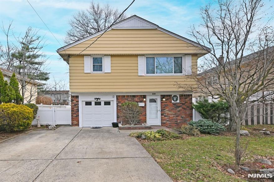 Immaculate, deceptively large home in quiet neighborhood of desirable Little Ferry , NJ. Over 2,000 sq ft, with all large rooms including large entry foyer, open living rm/dining rm combo, eat-in kitchen, 3 good size BRs including King Size Primary BR. 2 Updated Full Bathrooms! Additional features include Newer Roof, New Hot Water Heater, Central AC, hardwood flrs, attached garage plus double wide driveway for 4 cars, freshly painted and low taxes! All this plus a huge, fantastic ground floor Rec Room/ Family Rm or could even be a massive Primary Suite as it has the second full bathroom! New PVC Fenced Backyard with patio and BBQ Gas Line ready for your upcoming Spring and Summer gatherings! Also has tranquil pond and park across the road for your neighborhood enjoyment! Close to shops, restaurants & NYC Bus. Move in Ready ! Dont miss this one! Open house this Sunday 1-3pm.