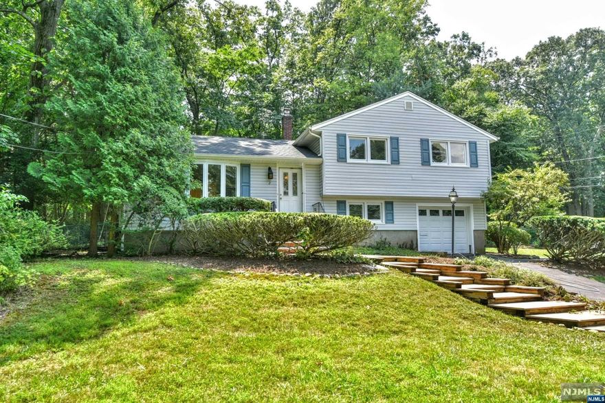 Welcome to Montvale, a special community with exceptional schools, relatively low taxes, both a train and bus to the city, as well as a plethora of shopping options! This warm and lovely home is situated on almost .44 acre of wooded property with plenty of room to expand. Dining room opens to living room, providing ample space for entertaining. Home offers a ground level family room plus a spacious basement. Brand new roof. Entire interior freshly painted, waiting for your updates and finishing touches. Enjoy spring and summer evenings on the patio or take a stroll through the quiet, somewhat secluded neighborhood that's also minutes from schools, shopping and transportation.