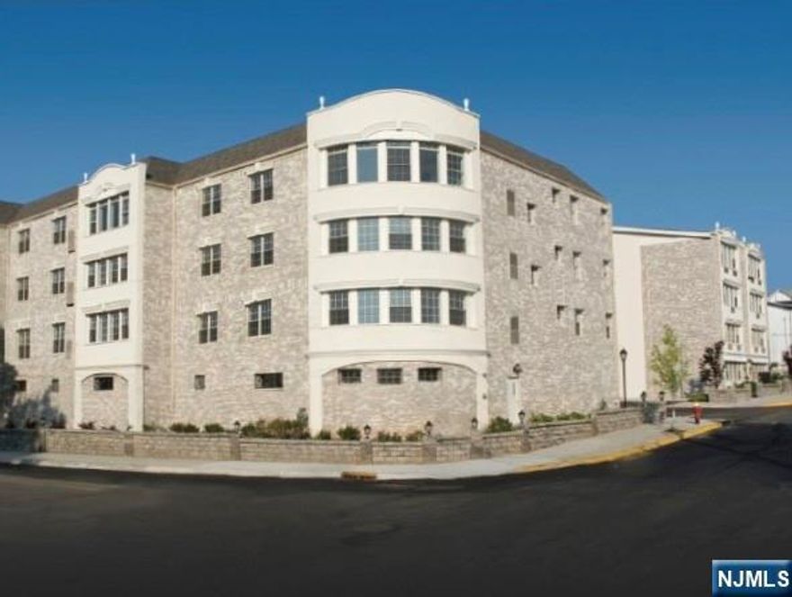 This elegant 2-bedroom, 2-bathroom condominium features a kitchen equipped with high-end granite countertops, ceramic tile flooring, and sophisticated stainless steel appliances. Residents can take in breathtaking corner views of the NYC skyline. Two assigned parking spaces accommodate two vehicles. The condominium's ideal location provides walking distance to public transportation and easy access to major highways. The condo features a pool and barbecue area with accompanying table and chairs.