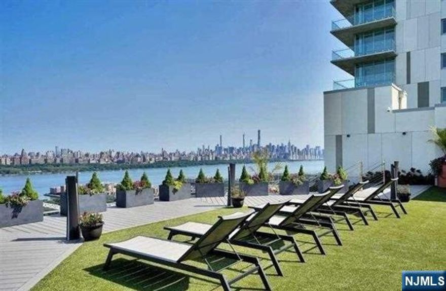 Step into elevated luxury at 320 Adolphus Avenue, Unit 812 in the prestigious One Park building. This stunning 2-bedroom, 2-bath residence offers partial Hudson River views and a sweeping NYC skyline backdrop, paired with the convenience of a covered parking space. Residents enjoy world-class amenities, including a 24-hour doorman, indoor heated pool, state-of-the-art fitness center, elegant residentsâ€™ lounge, indoor playroom, rooftop terrace with fire pits and BBQ area, golf simulator, and innovative robotic valet parking. Perfectly located in Cliffside Park for effortless commuting, with a bus stop right outside, complimentary shuttle to Port Imperial Ferry, and nearby Hudson-Bergen Light Rail access. Inside, youâ€™ll find floor-to-ceiling windows, a private balcony, white oak hardwood floors, zoned Daikin HVAC, in-unit washer/dryer, and a chefâ€™s kitchen featuring Thermador appliances and Cielo Quartzite countertops.