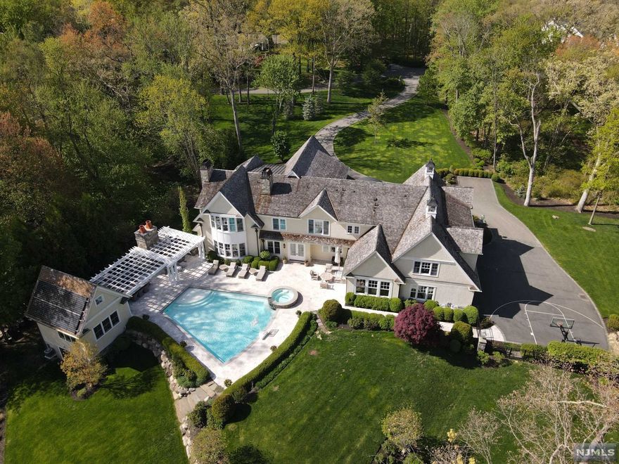 Chic, understated, timeless and welcoming. This 3.7 acre oasis is in one of Franklin Lakes most private yet convenient locations. A sweeping driveway introduces the Hampton style beauty offering over 10,600 sf on 3 levels. Heart-skipping, jaw-dropping property keeps on giving w/rolling lawns, ever changing gardens, private pond and salt water beach entry heated gunite pool. Entertain easily w/ your fav music or football game on the outdoor TV by the fpl! Friends gather by outdoor kit, pizza oven, and solar powered cabana w/ another kitchen, full bath, laundry and AC. New Bose speakers surround the pool to heighten the experience. The shingle and hand chiseled granite exterior compliment the exceptional build and design found inside. Salerno kit, hi-design GR,3 fpls, rustic fam rm, 1st fl guest rm. BRAND NEW LL w/EPIC media rm and wet bar,gym, guest area, bth and more. Smart home system for whole house control, 5G WiFi, radiant heat, whole house generator. A true Must-See!
